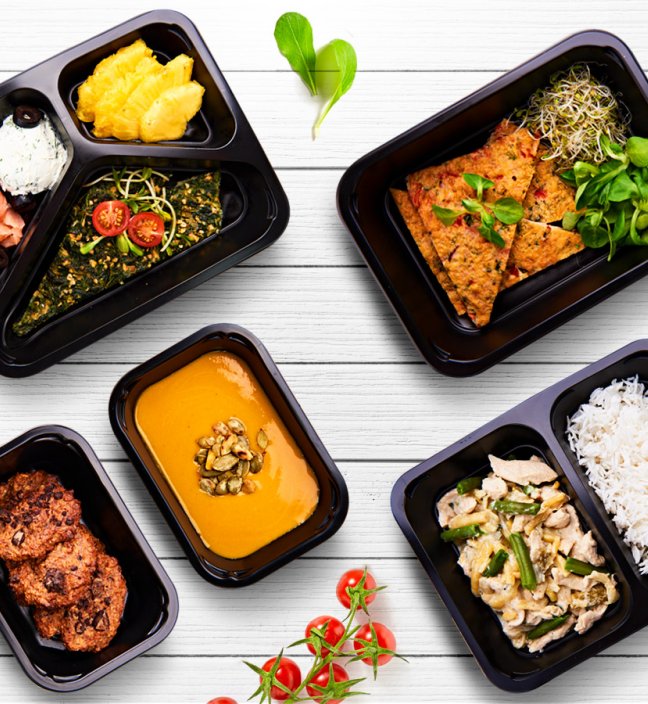 Top view of several healthy food dishes in plastic boxes for catering